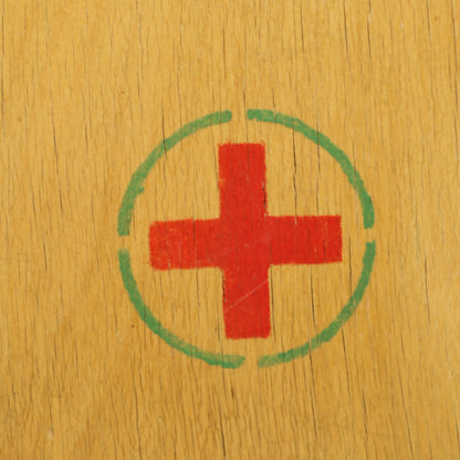 Red cross emblem on medicine cabinet door