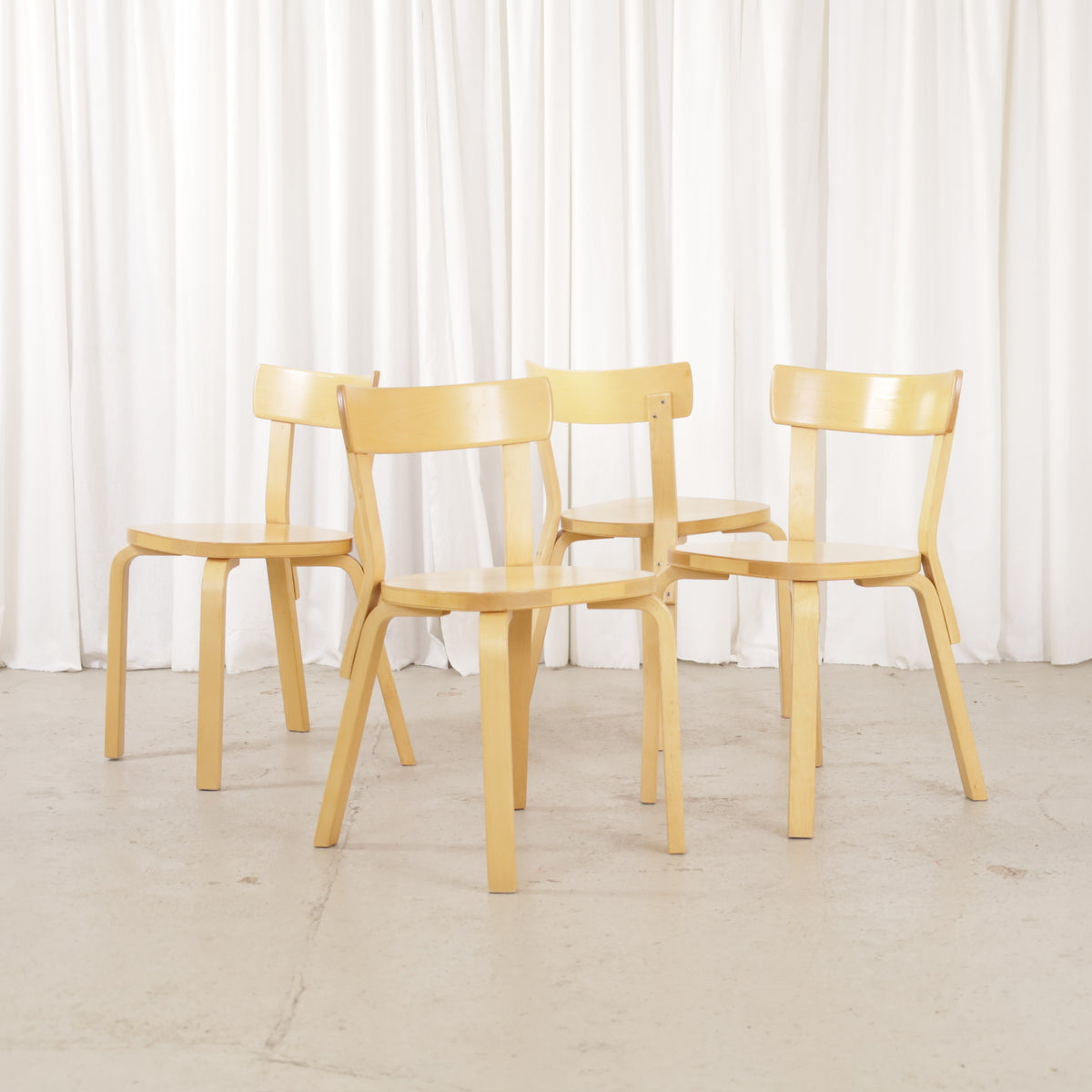 Four matching Artek Chair 69 dining chairs in birch
