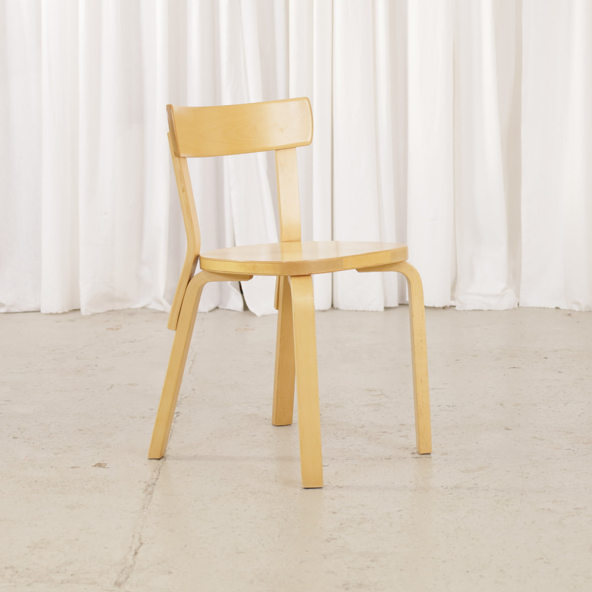 Alvar Aalto Artek Chair 69 in patinated birch, front three-quarter view
