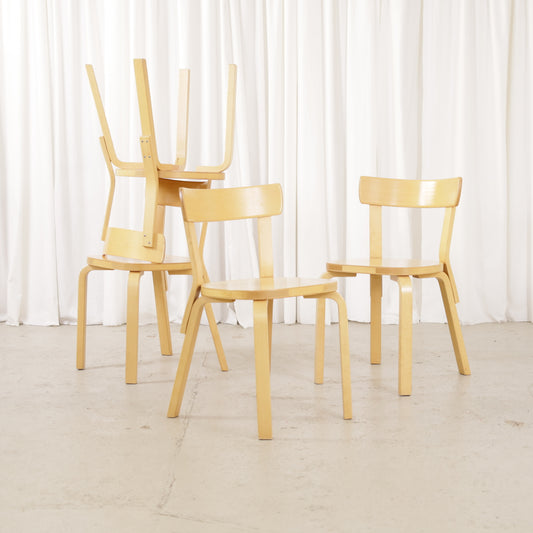 Four Artek Chair 69 chairs with one turned upside down to show the underside