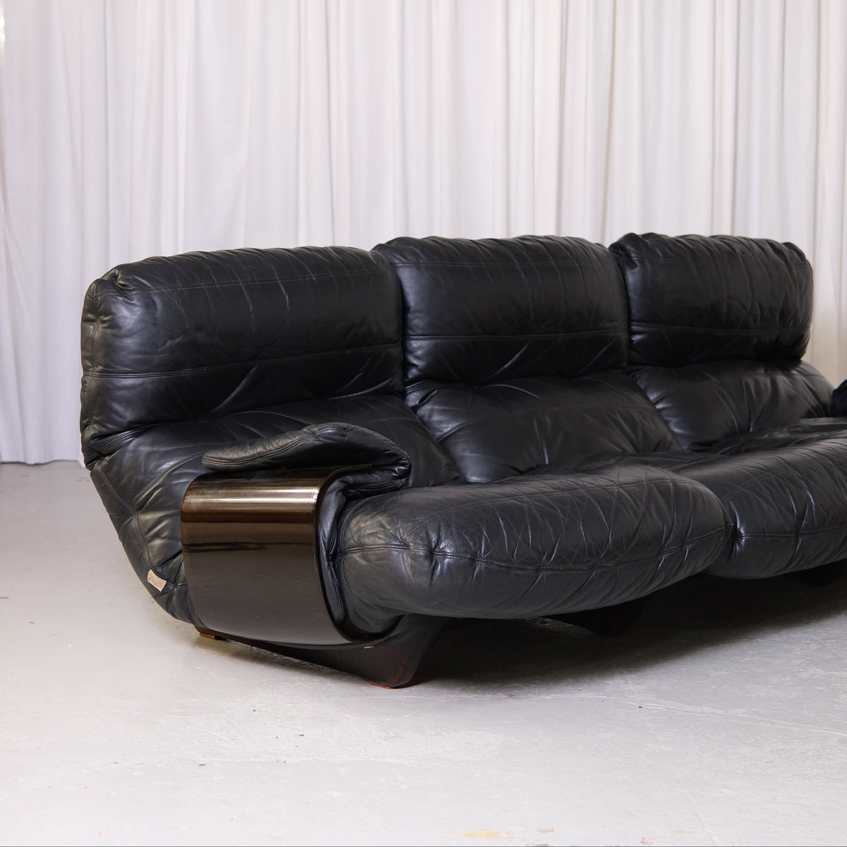 Detail of black leather cushions and acrylic armrest