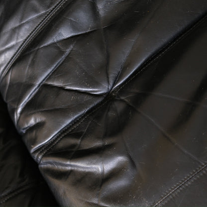Detail of seat button position and black leather surface