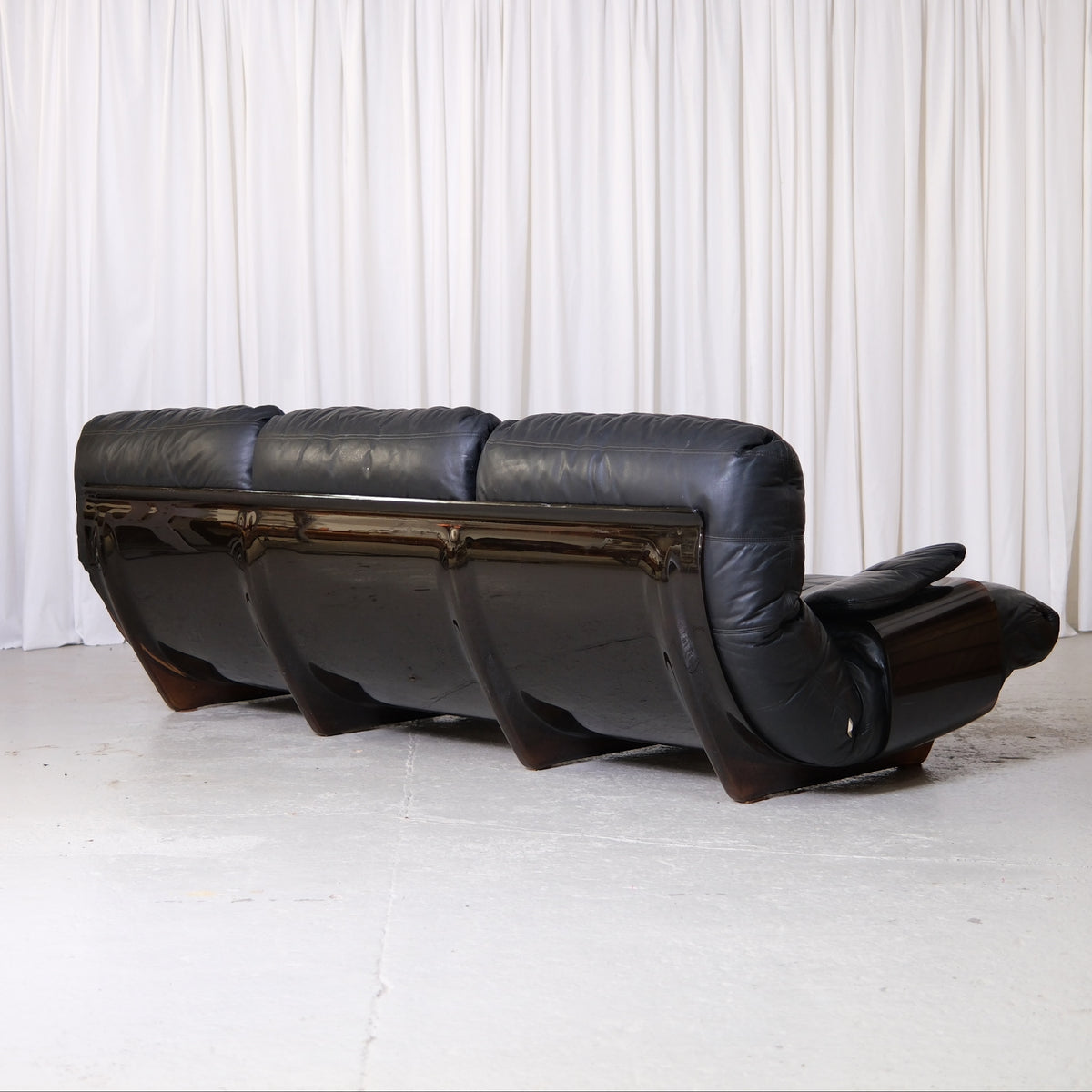 Rear view of three-seat Marsala sofa and curved acrylic shell