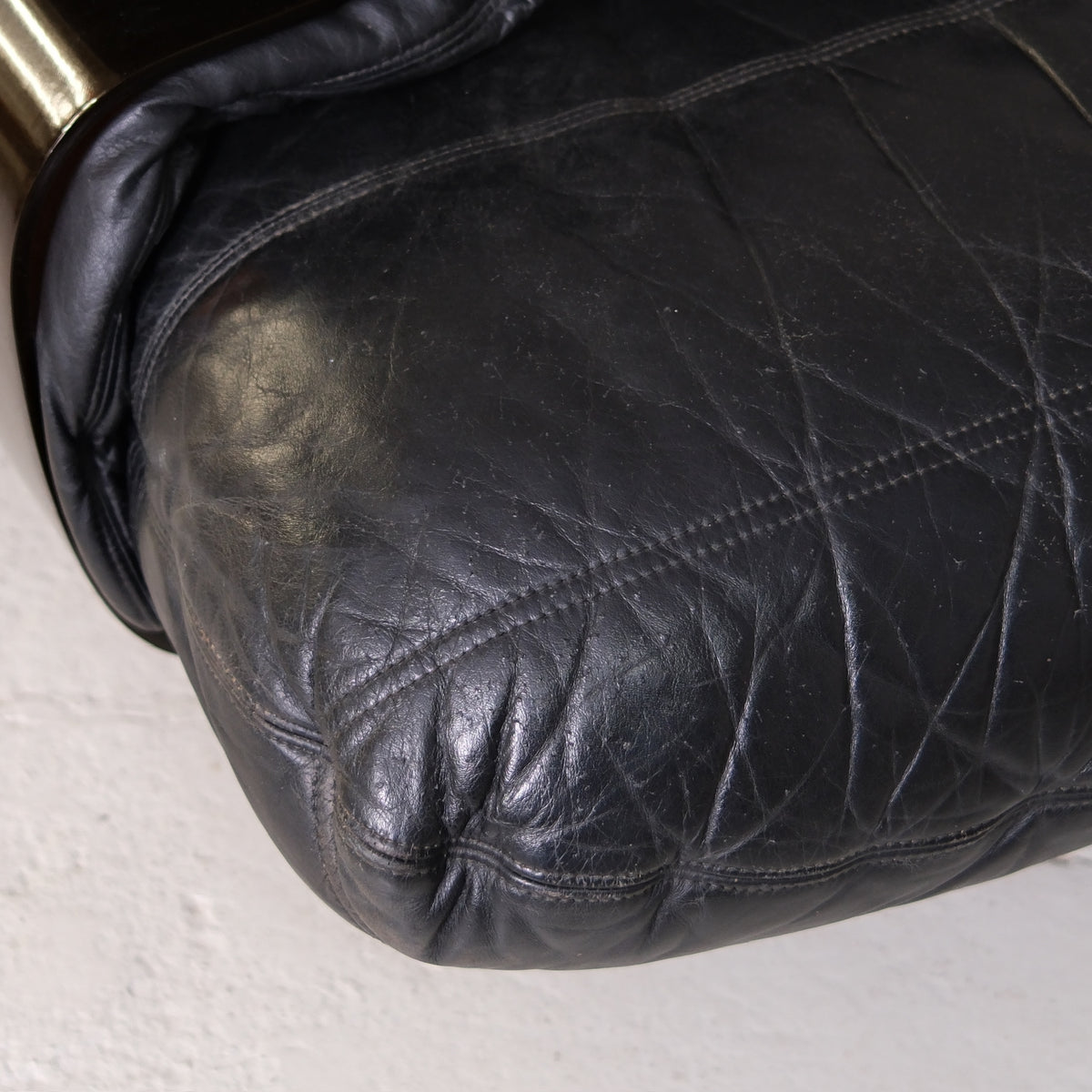 Close-up of black leather seat cushion and stitching