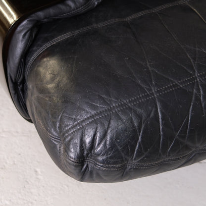 Close-up of black leather seat cushion and stitching