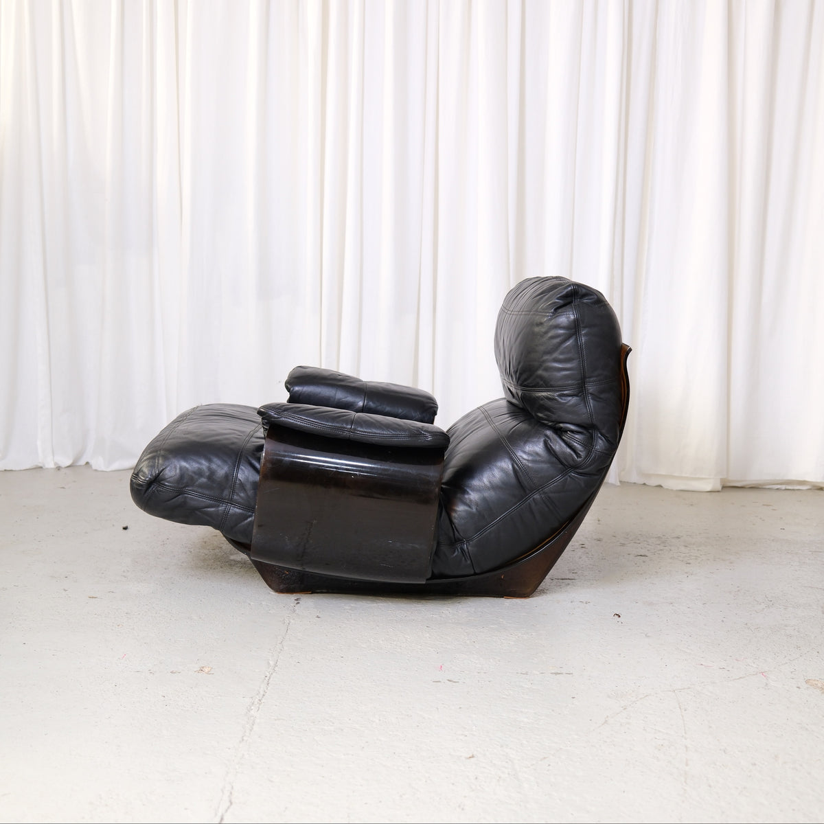 Marsala lounge chair with padded removable armrests, side view