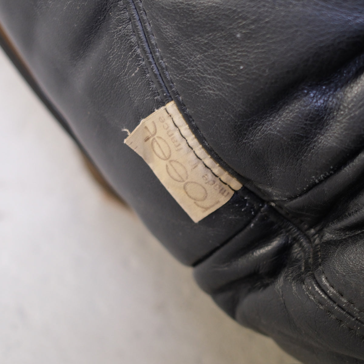 Ligne Roset fabric label on black leather upholstery