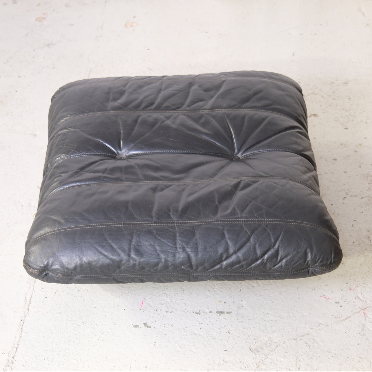 Matching Marsala ottoman with buttoned black leather cushion