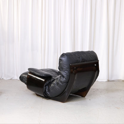 Marsala lounge chair, rear three-quarter view of smoked acrylic shell