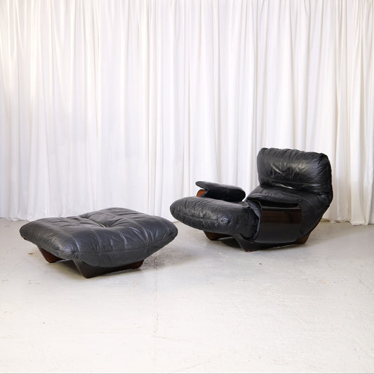 Marsala lounge chair and ottoman in black leather, front three-quarter view