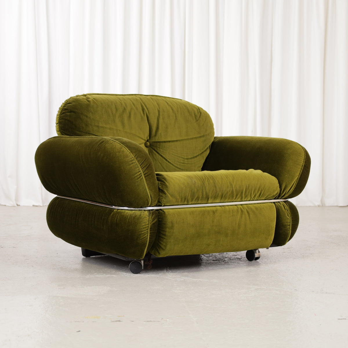 Isku Hannibal armchair in green velvet, three-quarter front view