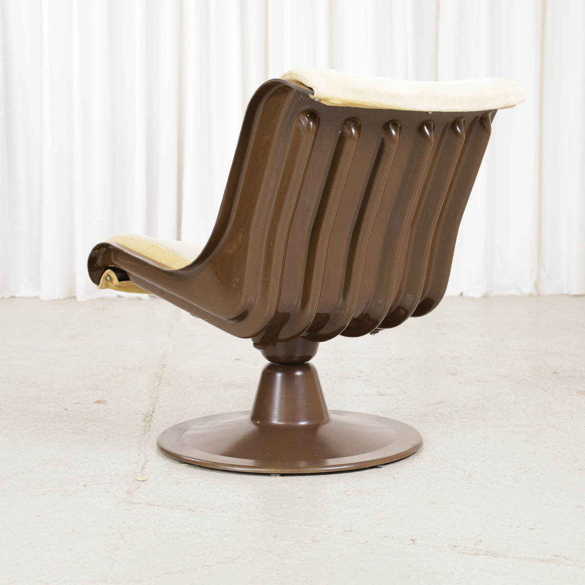 Yrjö Kukkapuro 3814-1KF chair, brown shell and pale yellow upholstery – three-quarter rear view