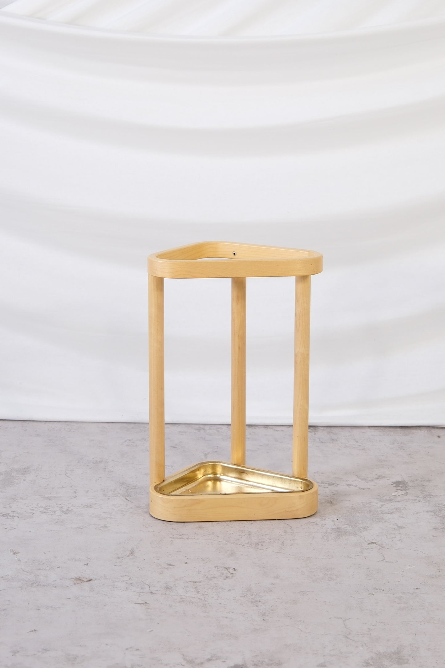 Artek umbrella stand designed by Alvar Aalto, natural birch frame with triangular brass tray, made in Finland 2007.