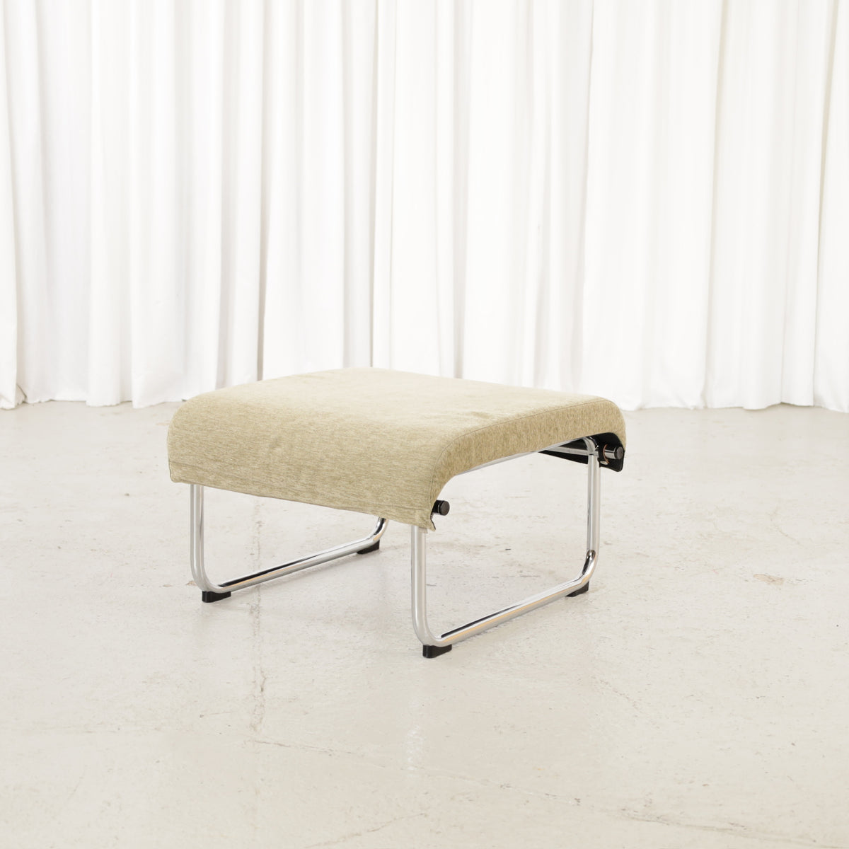 Green fabric Remmi ottoman, opposite angled view