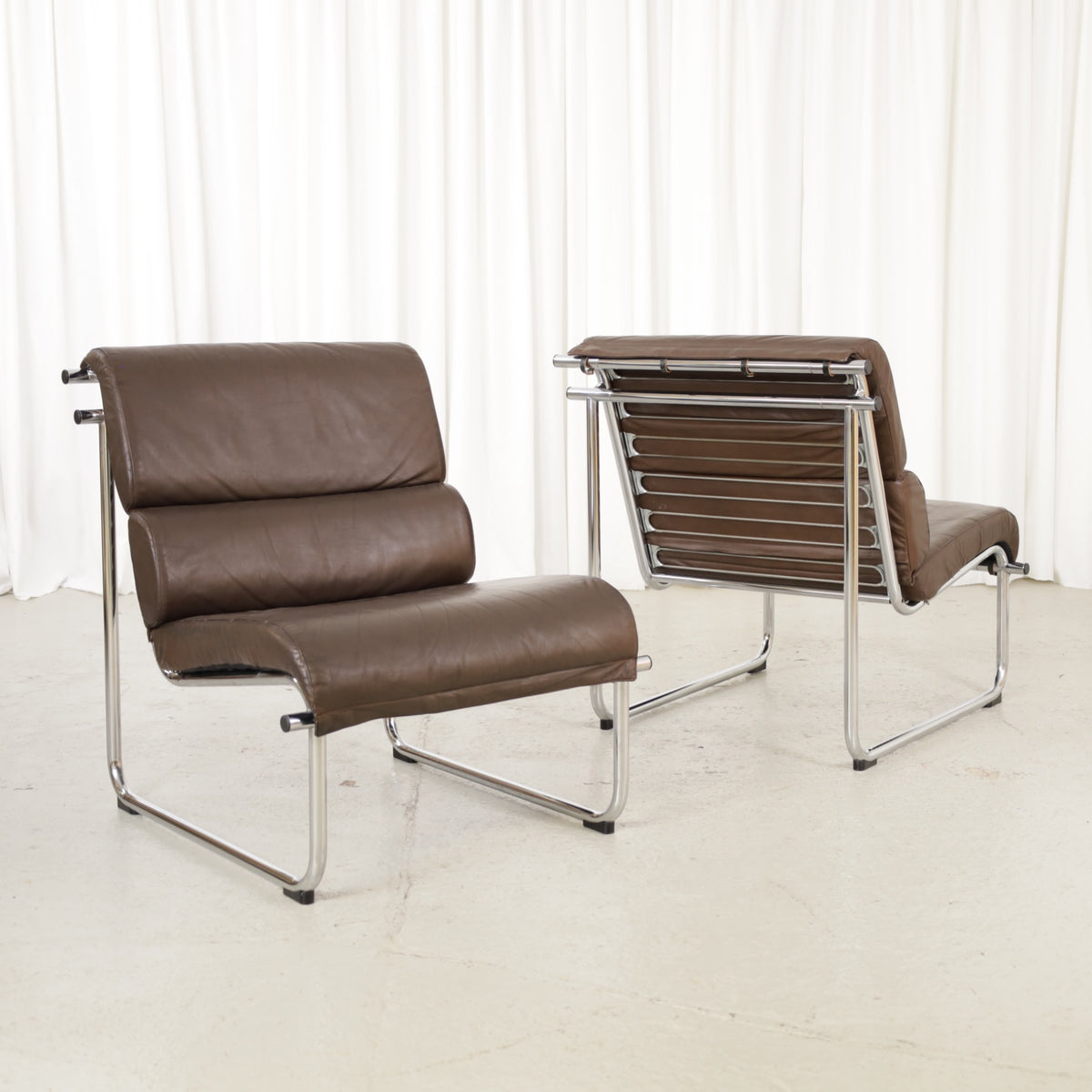 Yrjo Kukkapuro armless medium Remmi lounge chair in brown leather, two chairs shown, sold individually