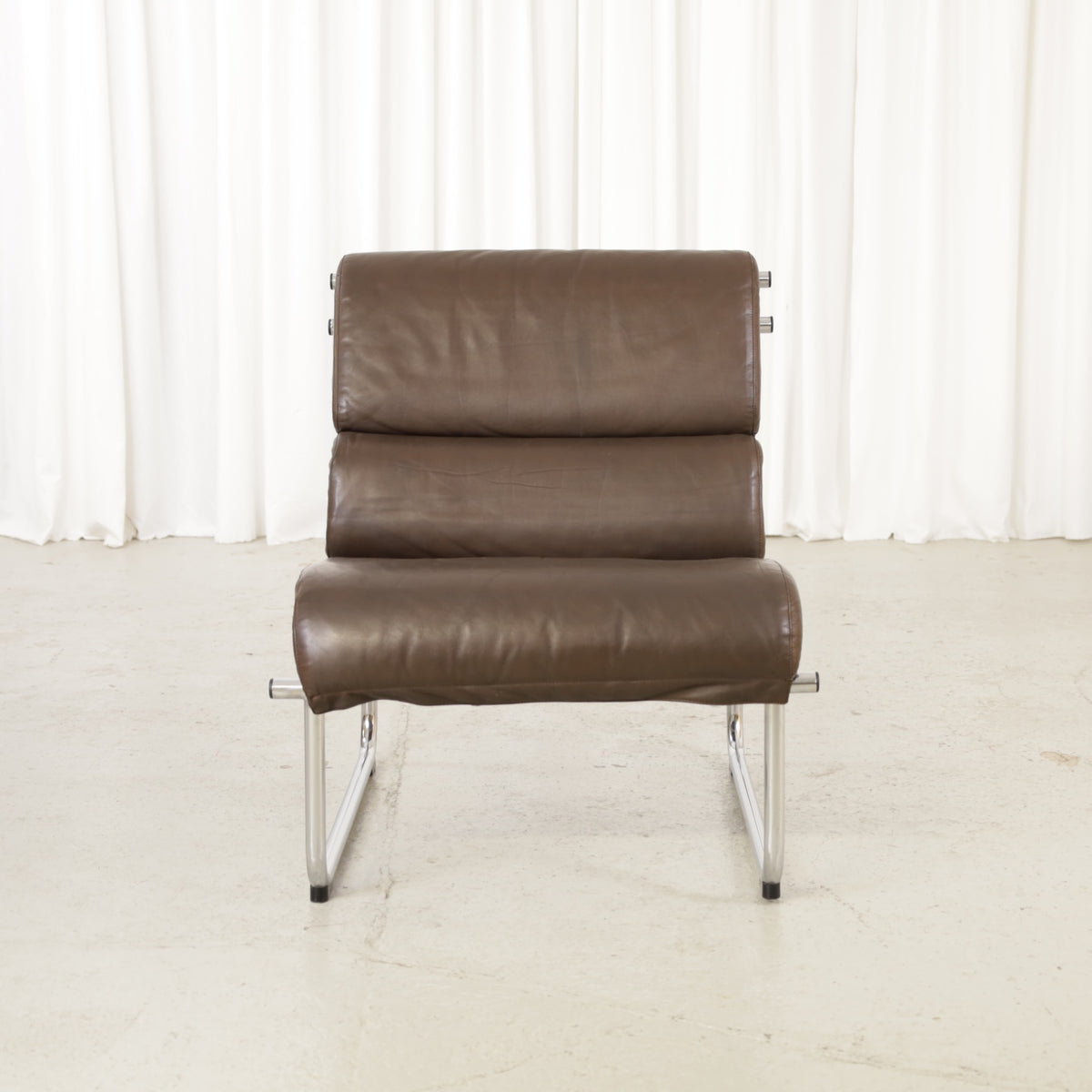 Yrjo Kukkapuro armless medium Remmi lounge chair in brown leather, chromed frame