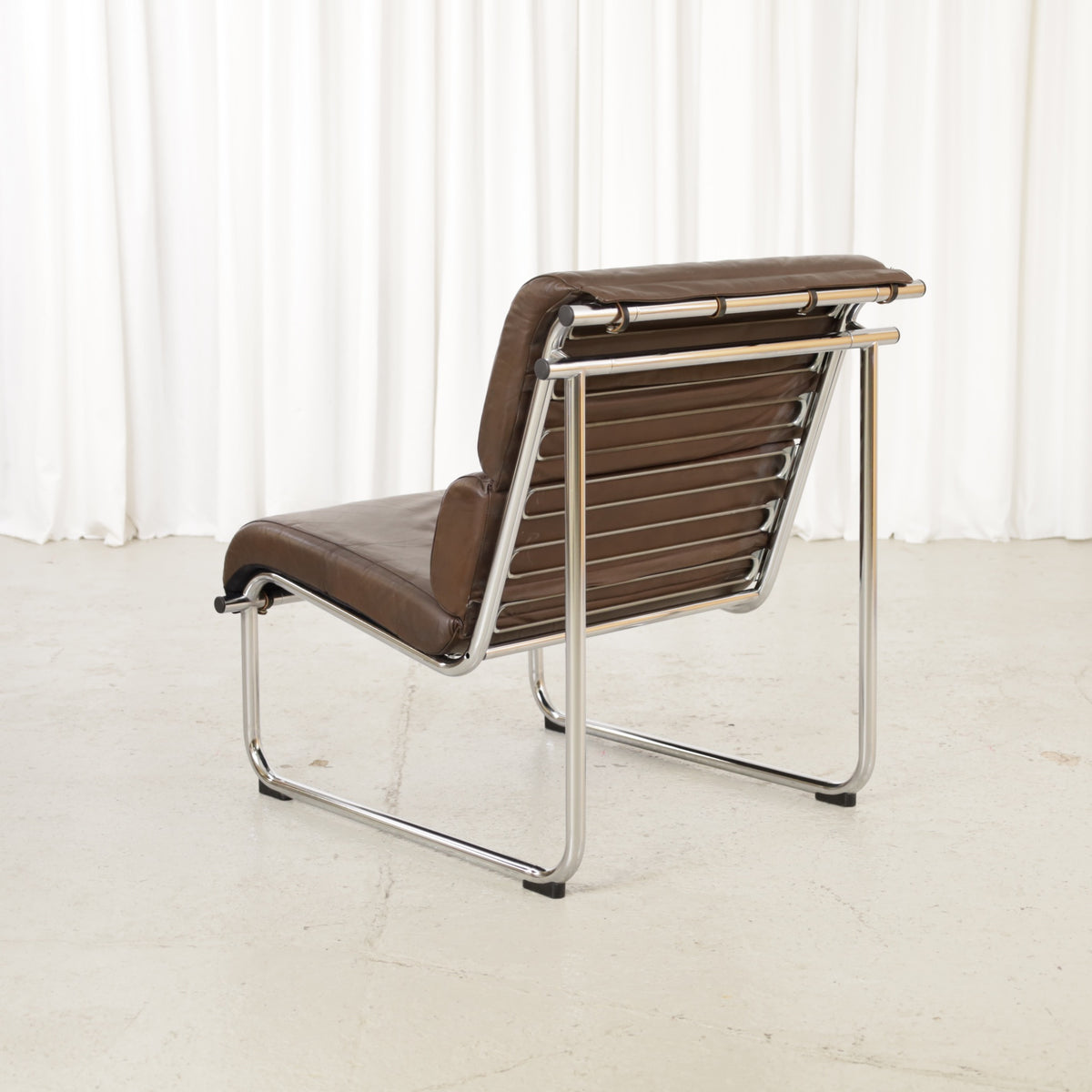Yrjo Kukkapuro Remmi medium lounge chair, brown leather and polished chromed frame