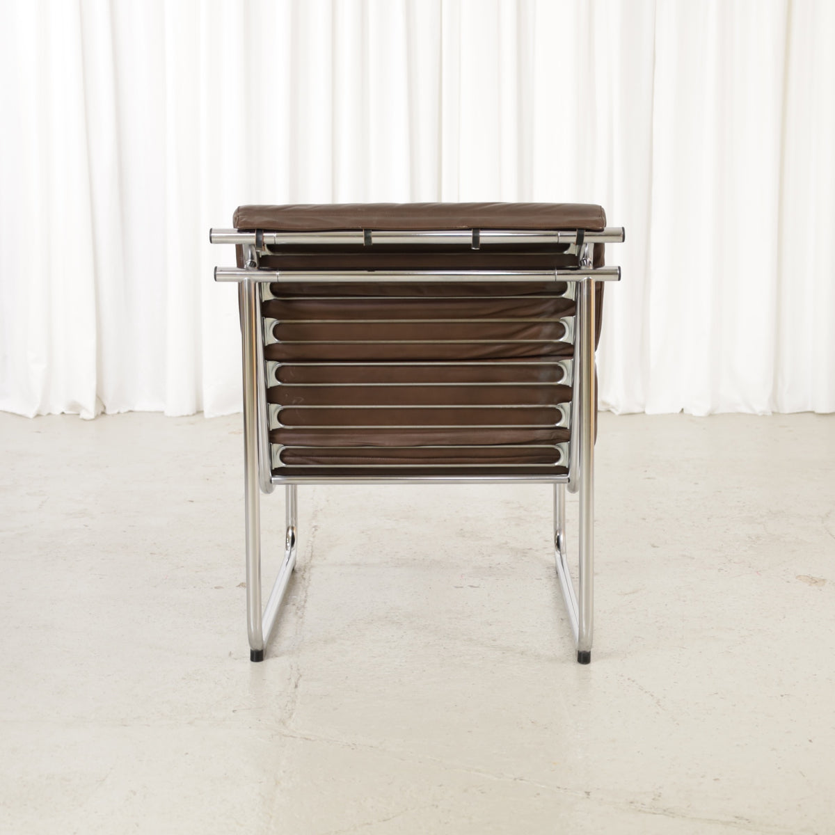 Yrjo Kukkapuro Remmi medium lounge chair, brown leather and polished chromed frame