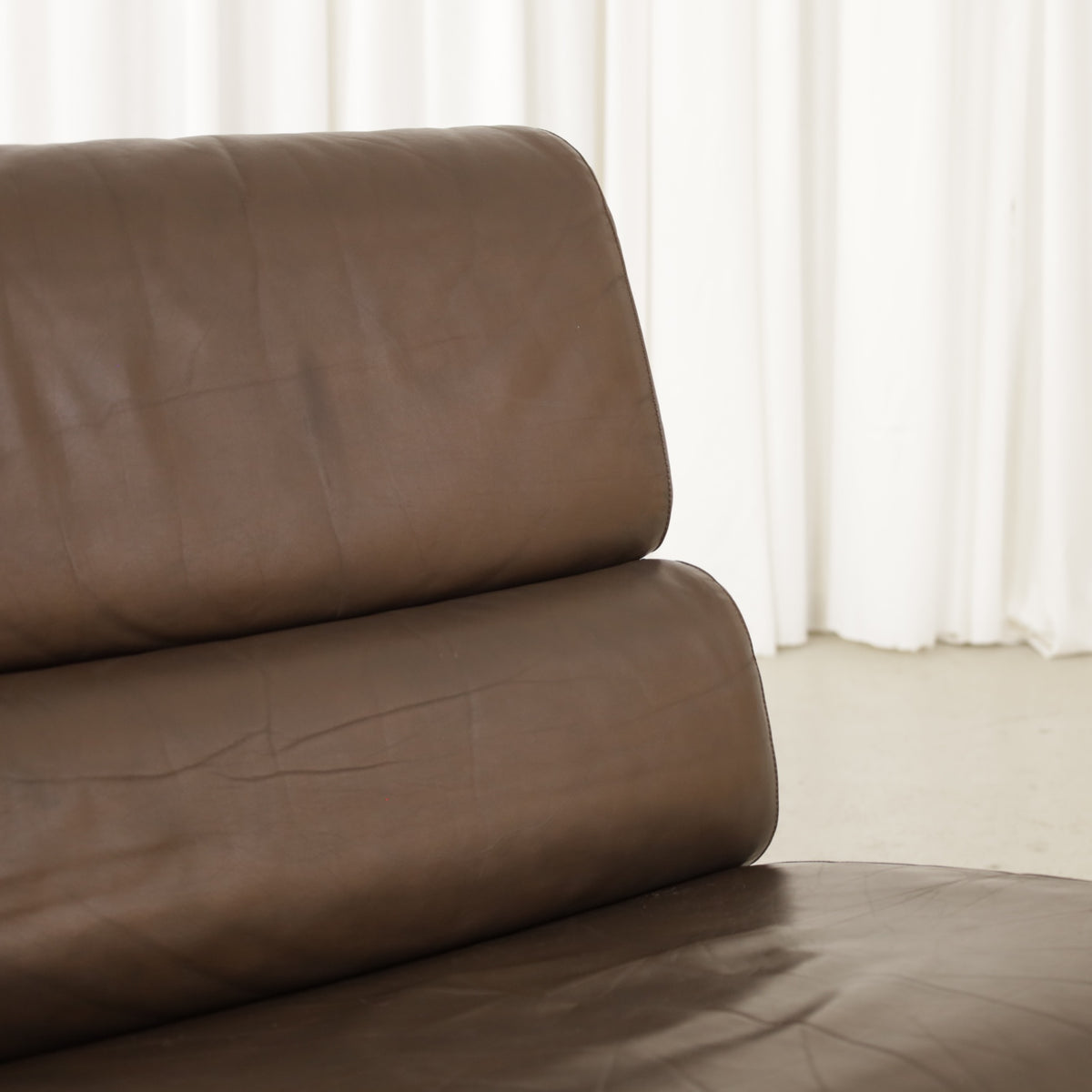 Yrjo Kukkapuro Remmi medium lounge chair, brown leather upholstery and chrome detail