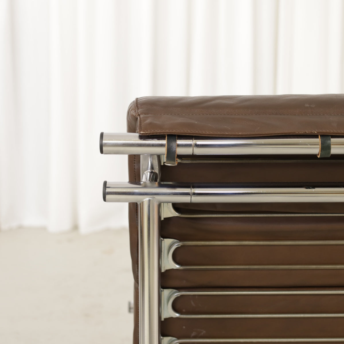 Yrjo Kukkapuro Remmi medium lounge chair, brown leather upholstery and chrome detail