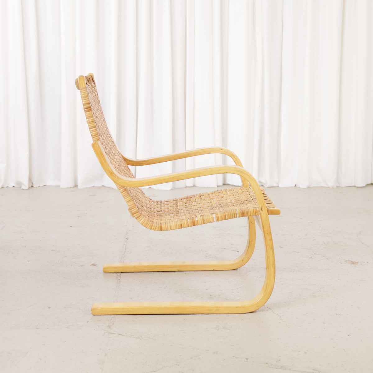 Alvar Aalto 406 lounge chair, rattan weave and birch frame