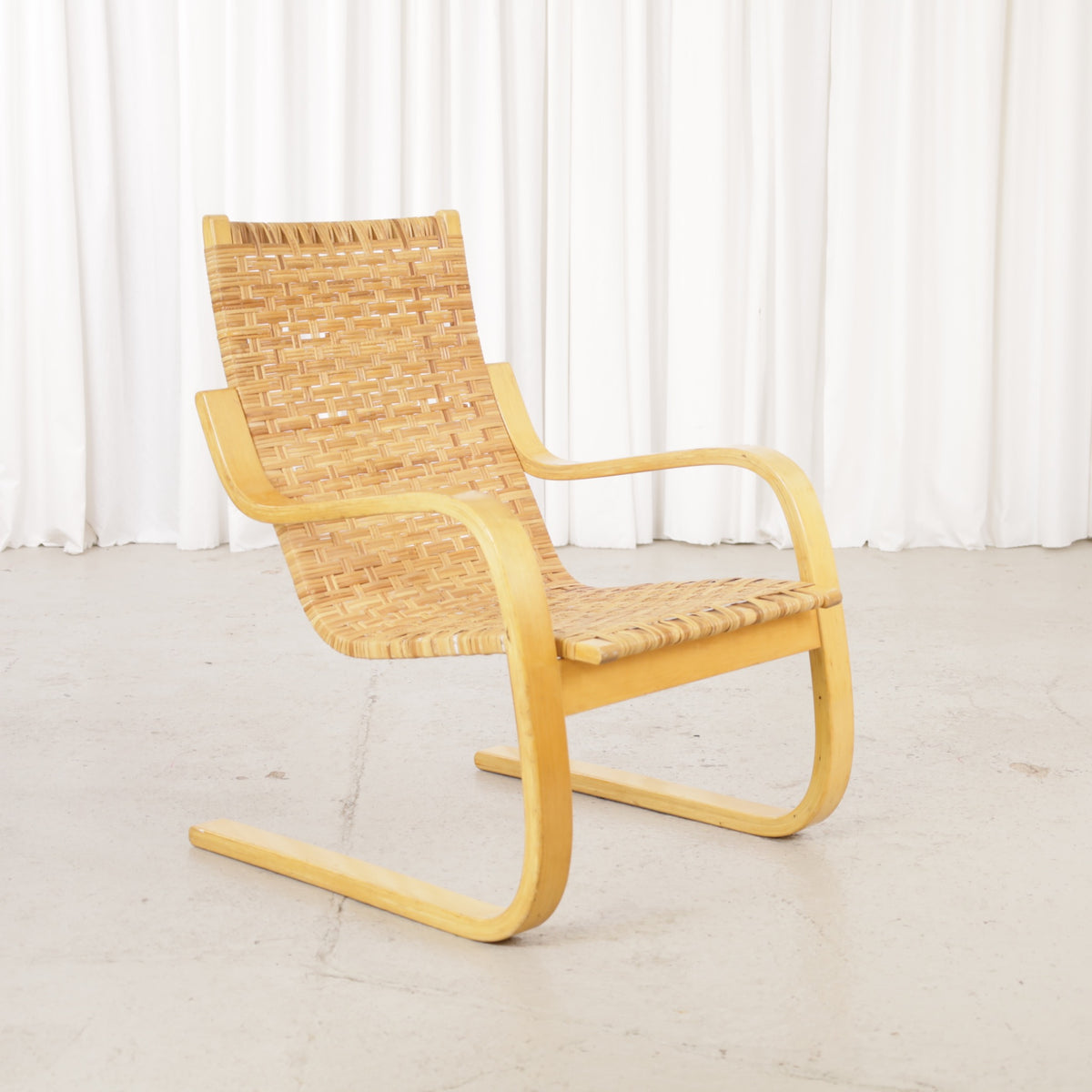 Alvar Aalto 406 lounge chair, rattan weave and birch frame