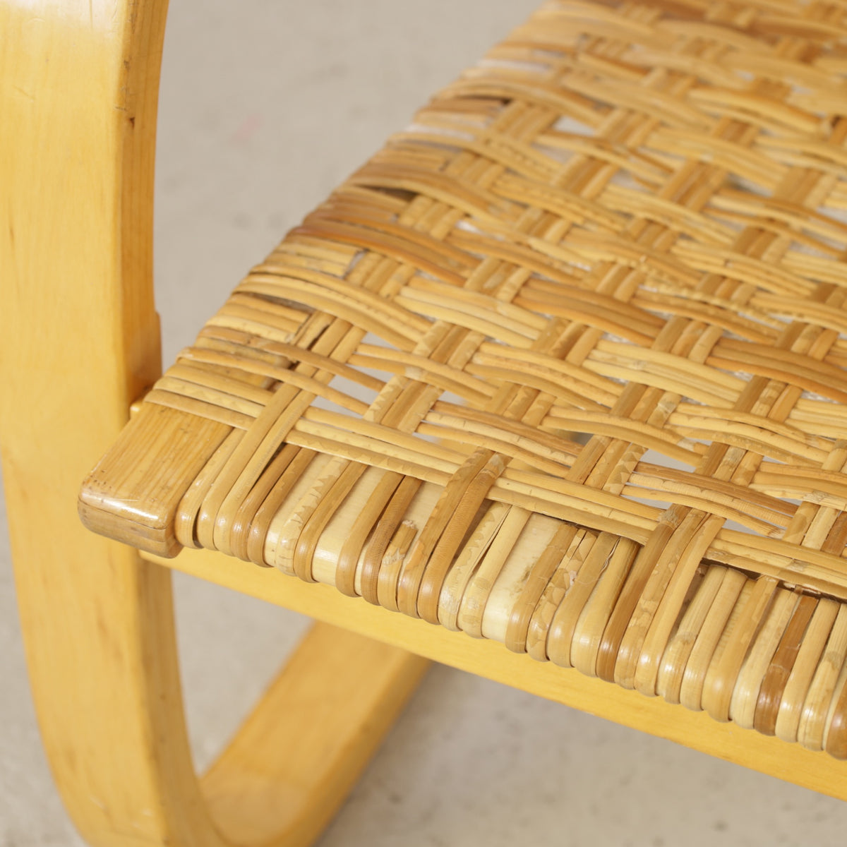 Alvar Aalto 406 lounge chair, worn and repaired rattan weave detail