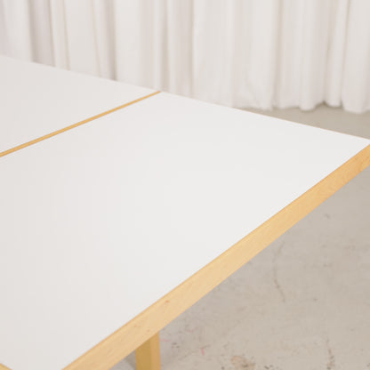 Artek drop-leaf table, white laminate surface and birch edge detail