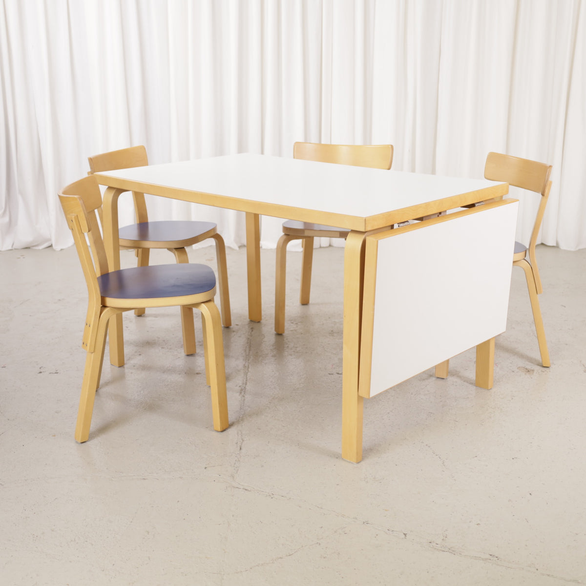 Artek drop-leaf table shown with chairs for scale; chairs not included