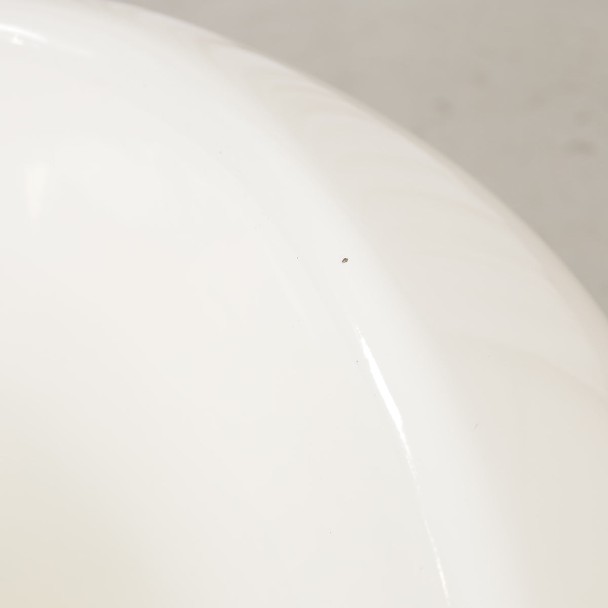 Close-up of small chip in white Pastilli chair finish