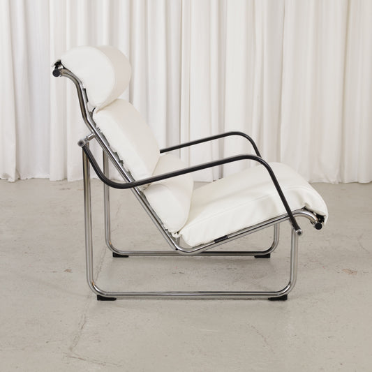 Side view of Remmi chair with chrome frame and black armrests