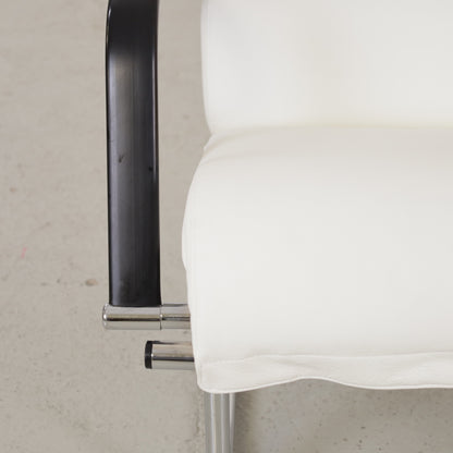 Detail of black armrest and white leather seat edge