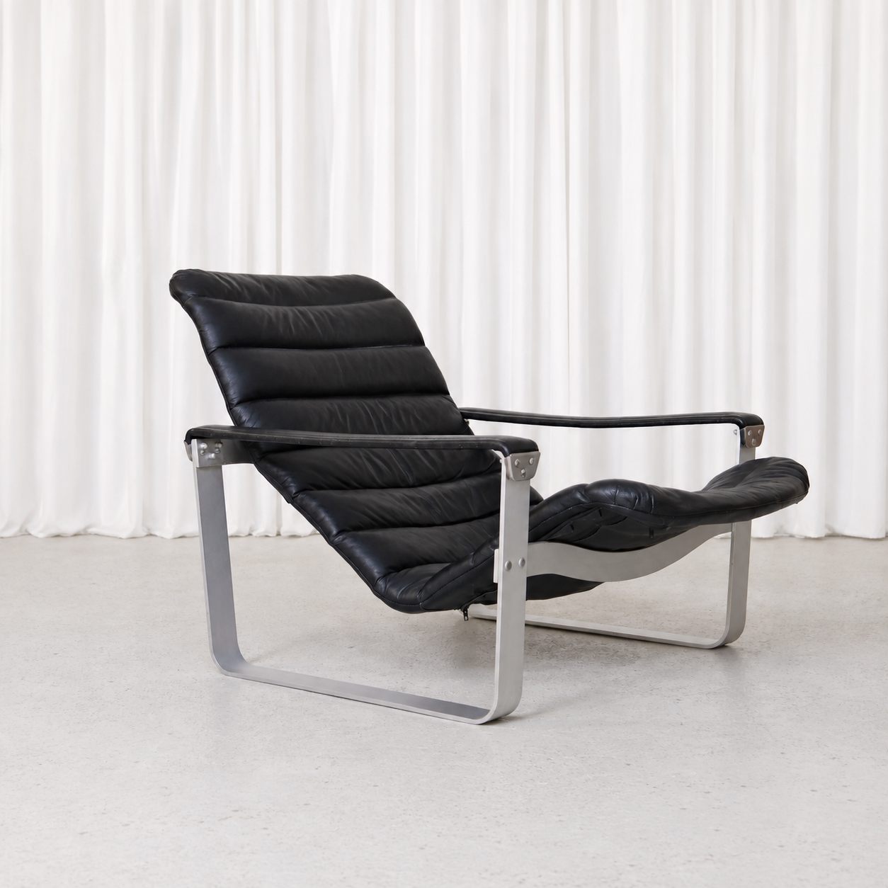Vintage Pulkka armchair by Ilmari Lappalainen for Asko Export. Black leather, brushed aluminium frame and adjustable seat in exceptional condition.