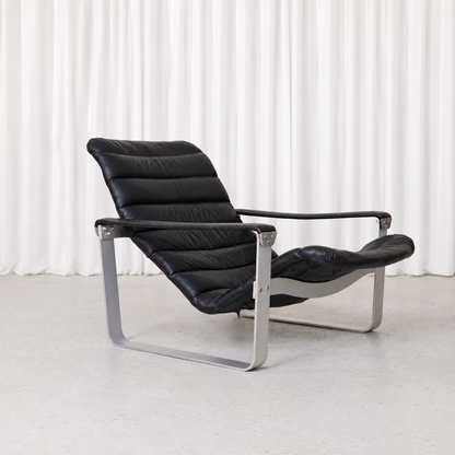 Vintage Pulkka armchair by Ilmari Lappalainen for Asko Export. Black leather, brushed aluminium frame and adjustable seat in exceptional condition.