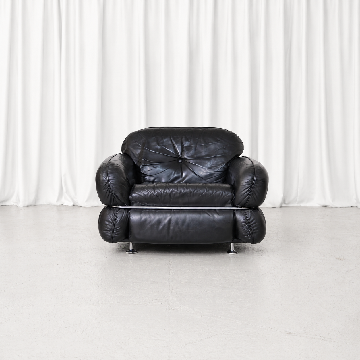 Vintage Isku Hannibal armchair designed by Kurt Hvitsjö in the 1970s, featuring original black leather upholstery and a distinctive tubular chrome frame.