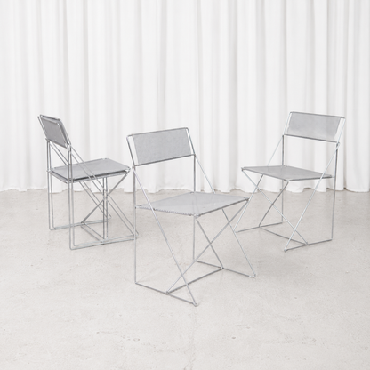 Vintage X-Line chair designed by Niels Jørgen Haugesen for Hybodan in 1977, featuring a chromed steel frame and perforated metal seat.
