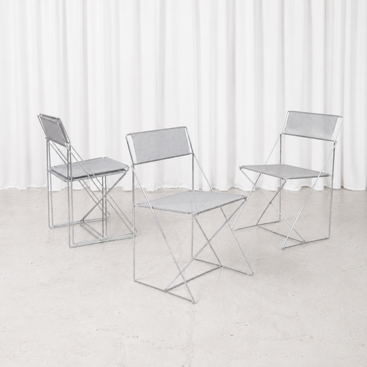 Vintage X-Line chair designed by Niels Jørgen Haugesen for Hybodan in 1977, featuring a chromed steel frame and perforated metal seat.