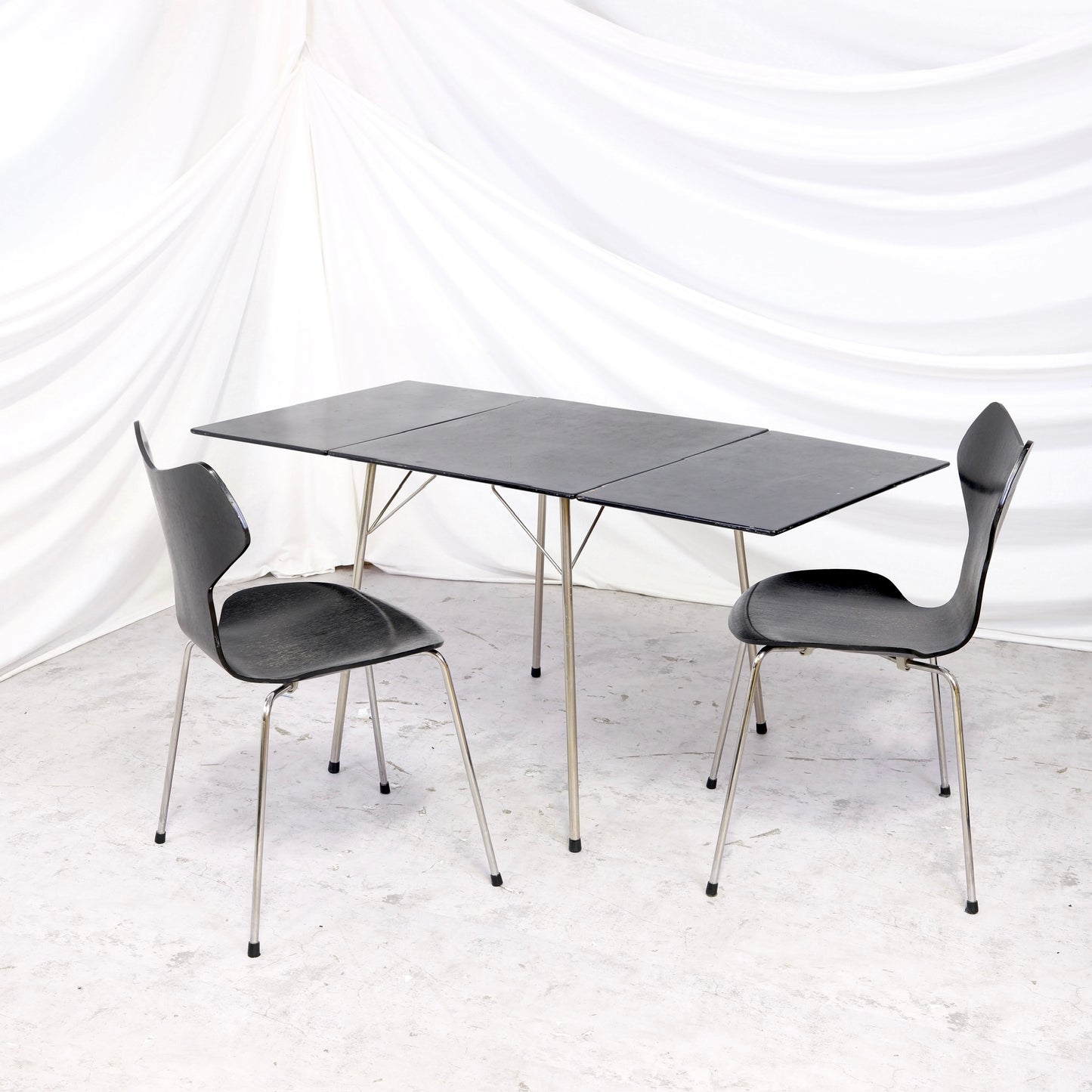 Rare vintage Fritz Hansen Model 3601 drop leaf table in black with metal legs, shown folded and fully extended