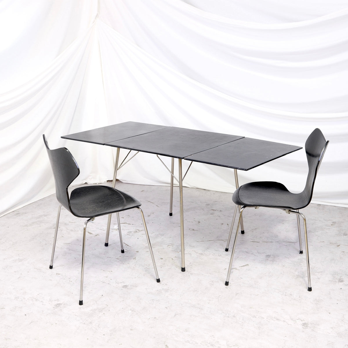 Rare vintage Fritz Hansen Model 3601 drop leaf table in black with metal legs, shown folded and fully extended