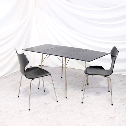 Rare vintage Fritz Hansen Model 3601 drop leaf table in black with metal legs, shown folded and fully extended