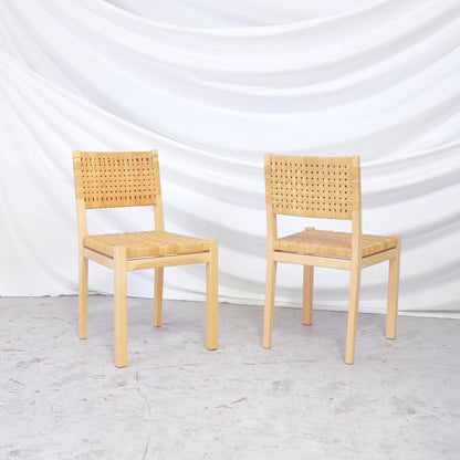 Set of 2 vintage Aino Aalto 615 chairs in birch and rattan. Finnish design classics with natural texture and timeless form. Worldwide shipping available.