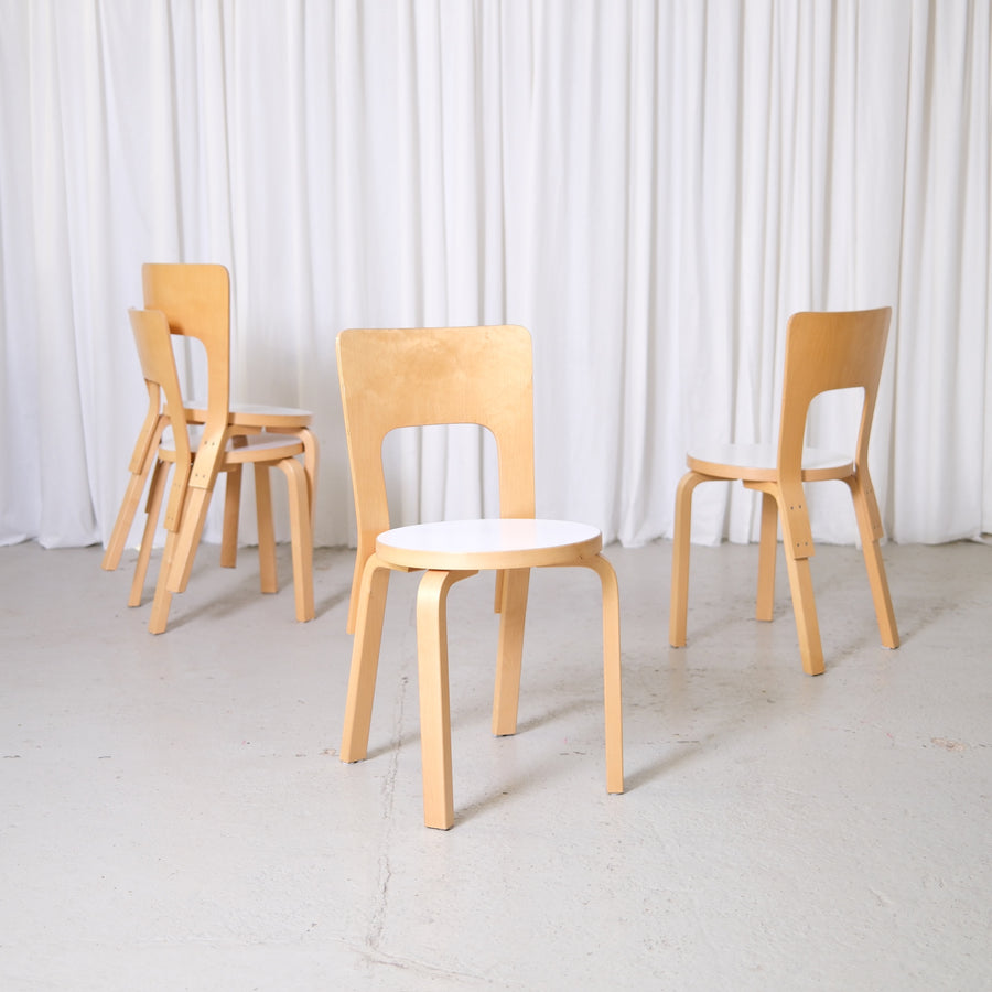 Vintage Alvar Aalto Artek 66 chairs with birch frames and white laminate seats