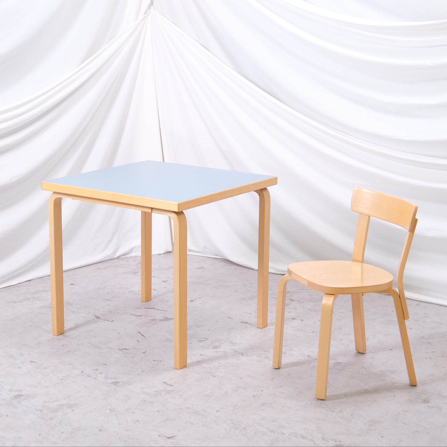 Vintage Artek 81C table by Alvar Aalto with baby blue linoleum top and birch frame. Finnish design classic from Helsinki. Worldwide shipping available.
