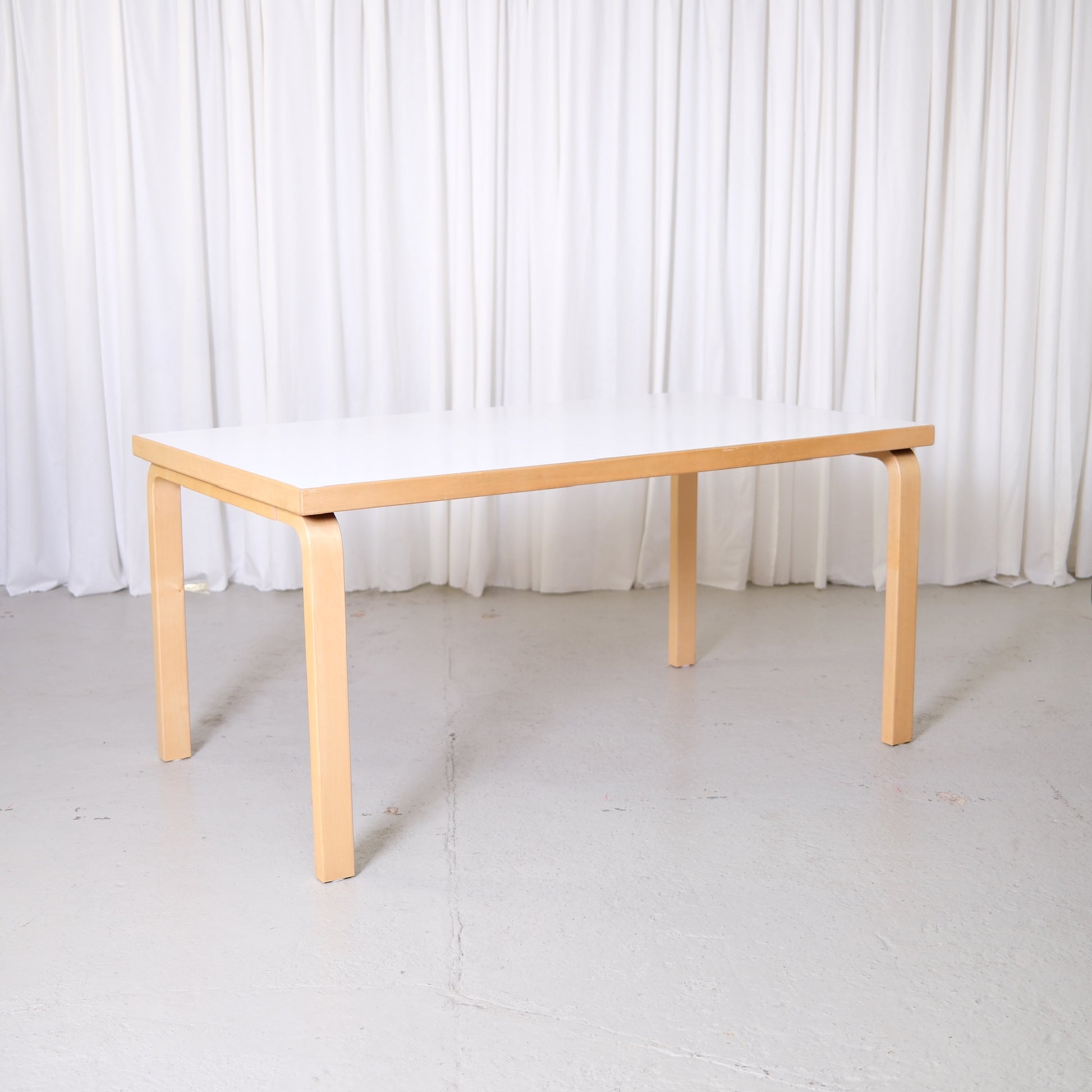Vintage Alvar Aalto Artek 82A table with white laminate top and birch legs, Finnish design dining table photographed at Pino Interiors Helsinki.