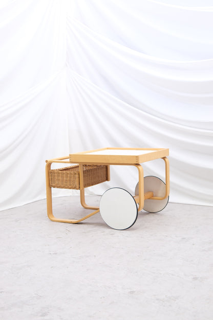 Original vintage Artek 900 serving trolley by Alvar Aalto with white tiled surface. Iconic Finnish utility design with worldwide shipping.

