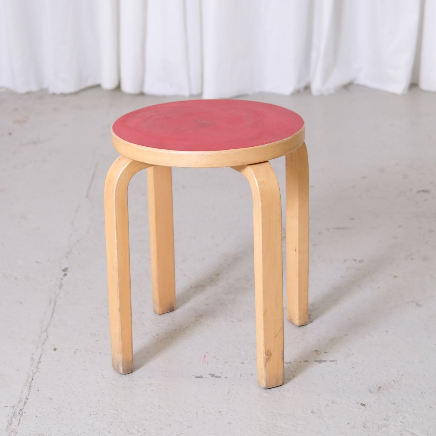 Vintage Alvar Aalto Artek E60 stool with red linoleum seat and birch legs