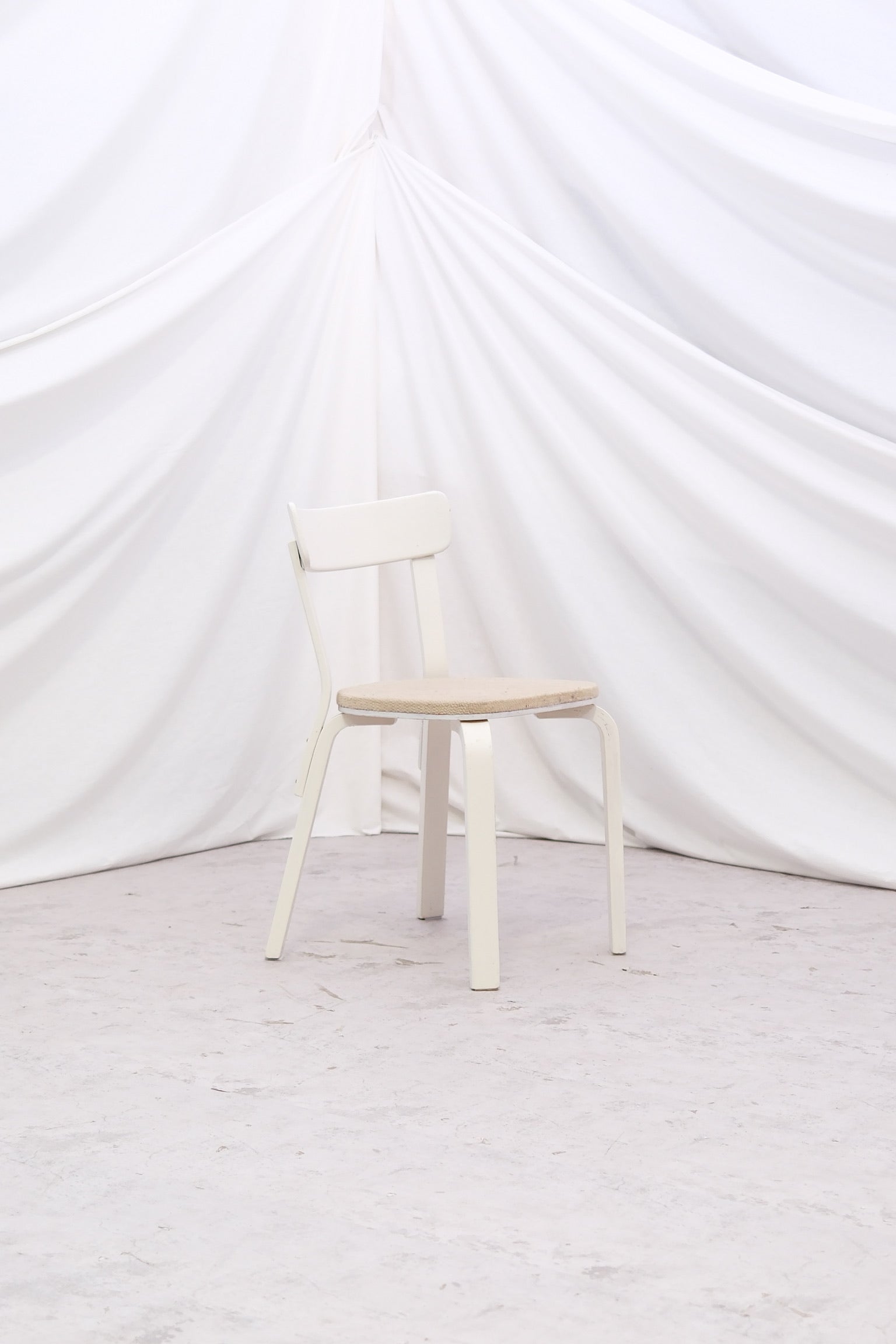 Vintage Alvar Aalto Chair 69 “Sandwich” by Artek with original upholstery and white painted finish with patina. Helsinki pickup and worldwide shipping available.