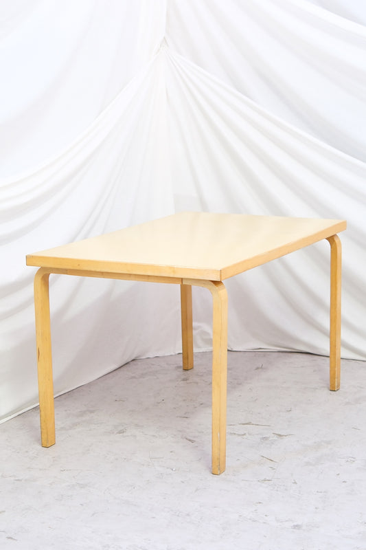 Artek 81B dining or work table with yellow laminate top. Honest vintage character and solid structure. Two tables pictured. Worldwide shipping.