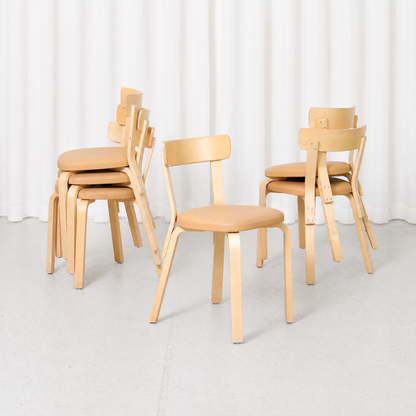 Vintage Artek Chair 69 designed by Alvar Aalto, featuring a birch frame and beige upholstered seat. Good vintage condition with minor wear.