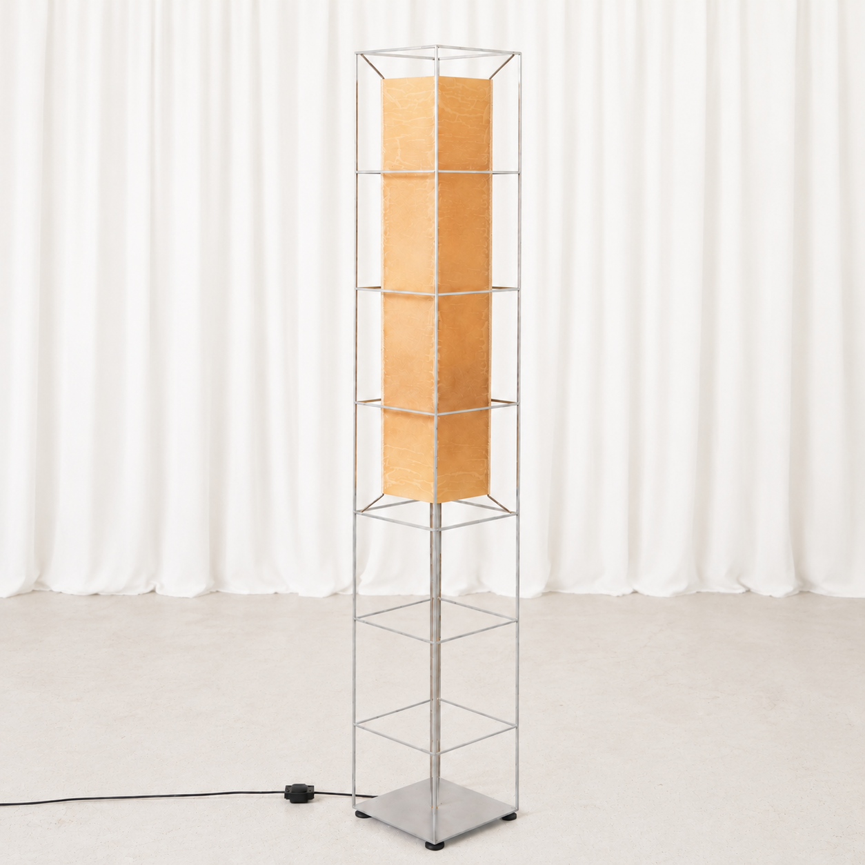 Sculptural vintage brutalist floor lamp with a chrome-plated wire frame and warm beige inner shade. A striking statement light for a modern interior.
